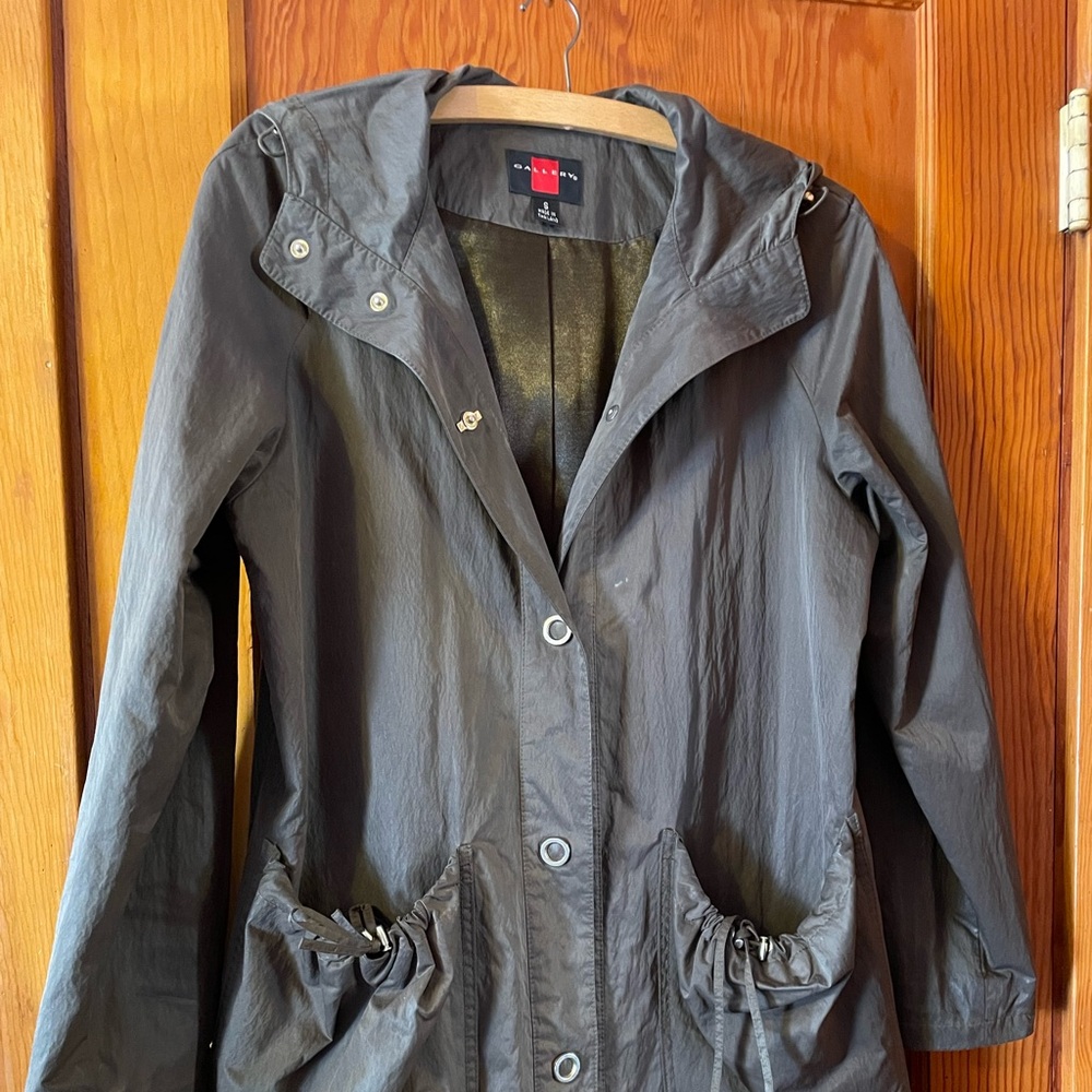 Dark green woman’s waterproof hooded rain coat.